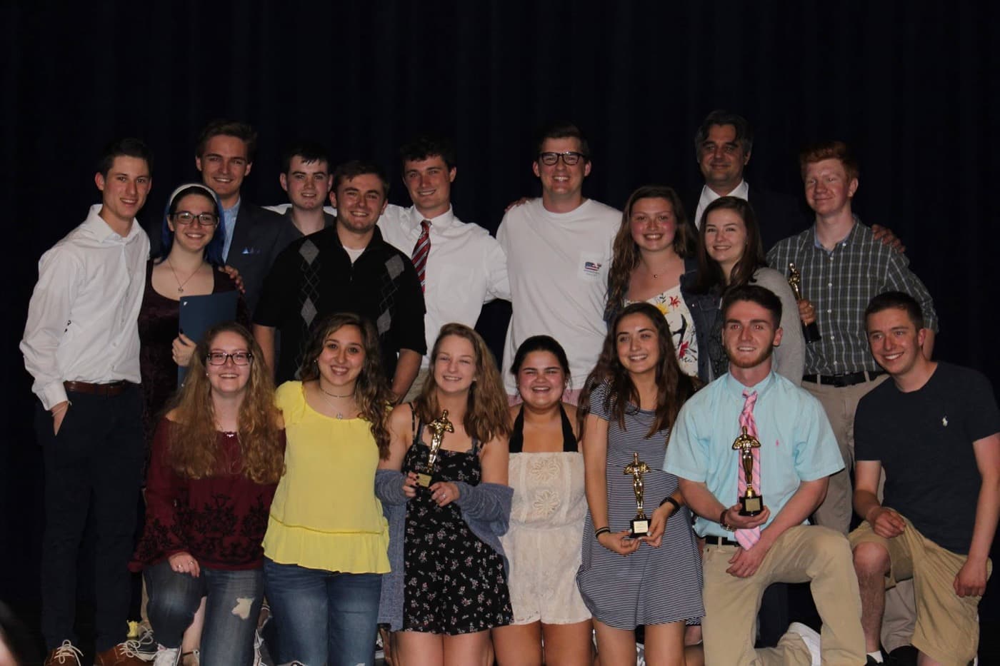 Jeb Brunt with students holding awards at a national student media ceremony